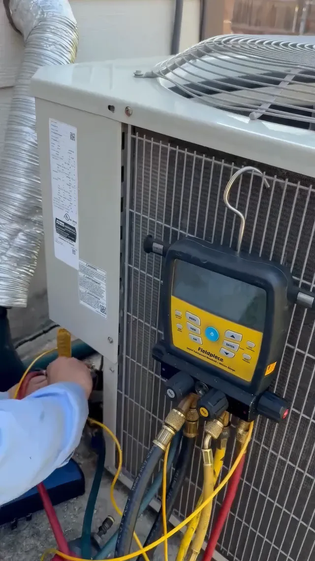 Digital refrigeration gauge manifold connected to a condenser