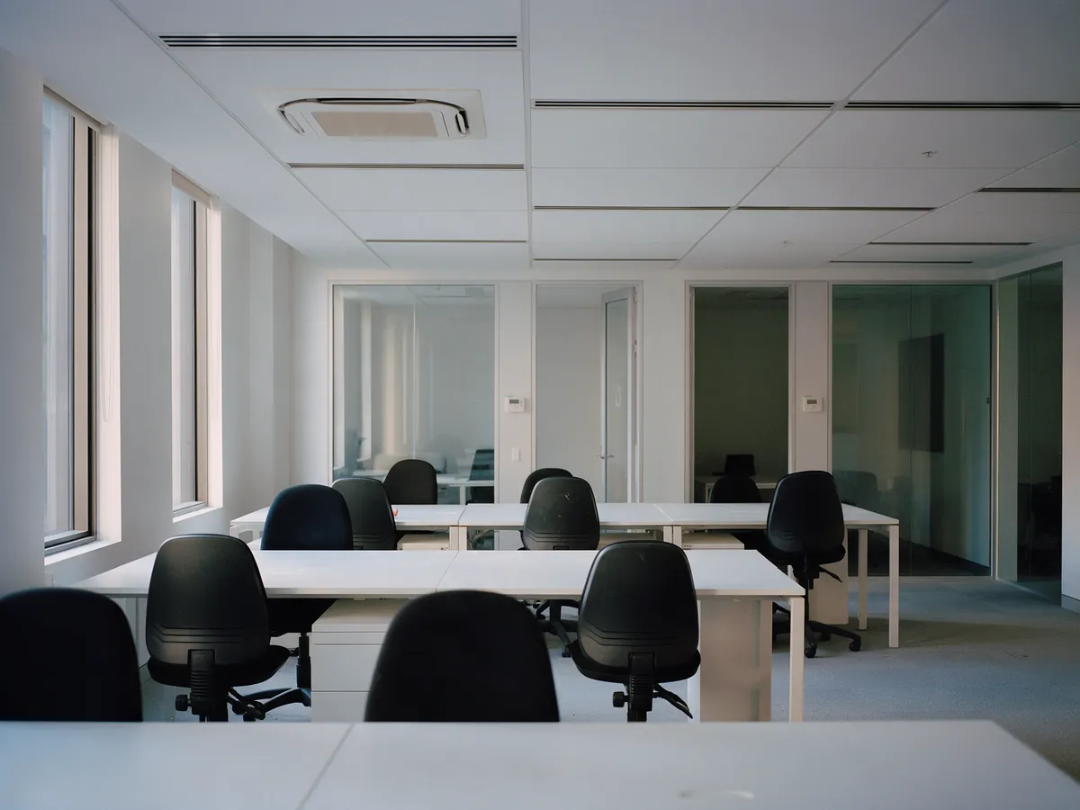 Newly fitted open-plan office with slot diffusers and a ceiling cassette
